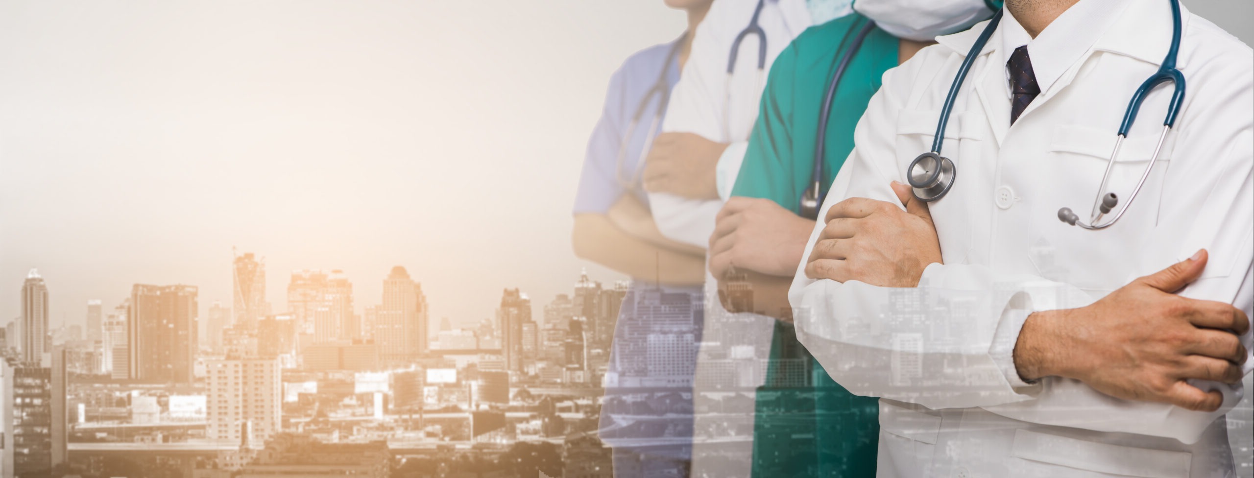 Advertise, hospital, profession and medicine concept - Cropped image of Team of doctors and nurses with stethoscopes and background blur building skyscrapers at sunset. Panorama