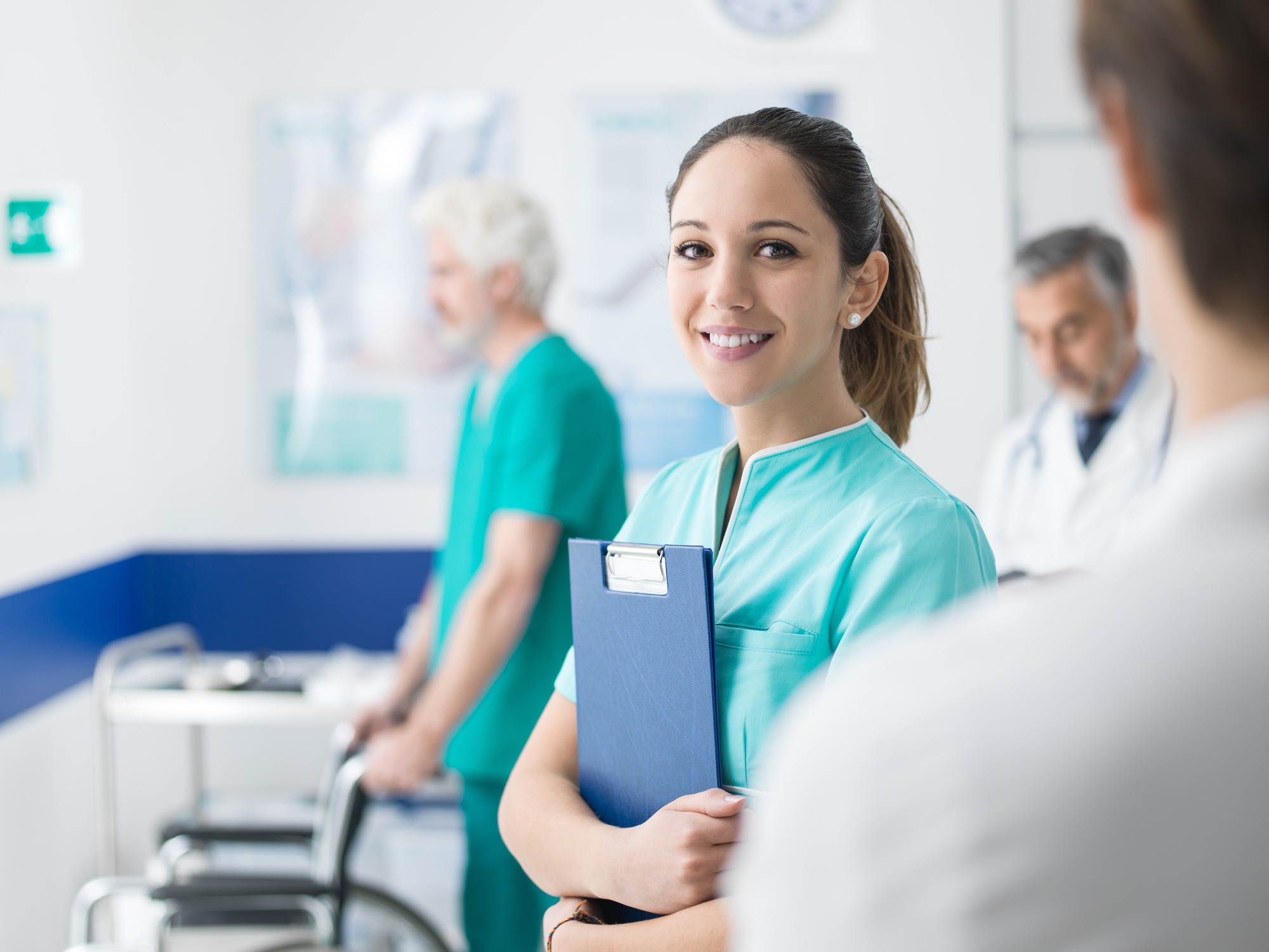 Young female medical student working at the hospital and medical staff